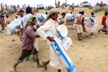 Yemenis displaced from areas near the border with Saudi Arabia receive humanitarian aid given by the Norwegian Refugee Council (NRC) and the UN High Commissioner for Refugees (UNHCR) in the northern province of Hajja on March 11, 2019. AFP