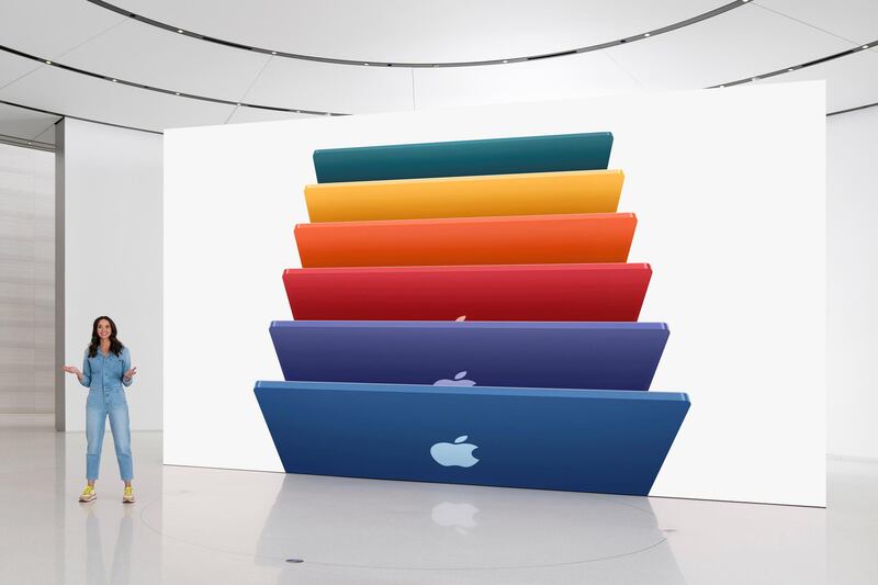 Apple's Colleen Novielli showcases the new iMac lineup featuring an array of colors during the event. Reuters