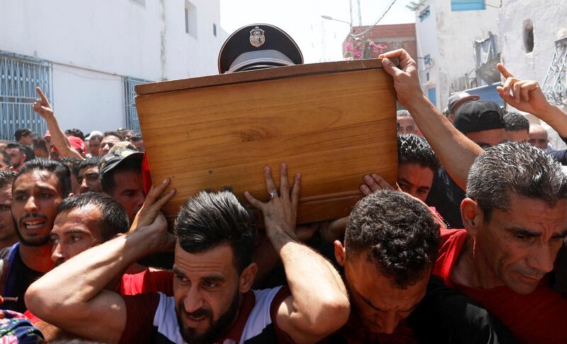 Men carry the coffin of a police officer who was killed during a suicide bomber attack, during his funeral in Sidi Hassine, Tunisia. Reuters