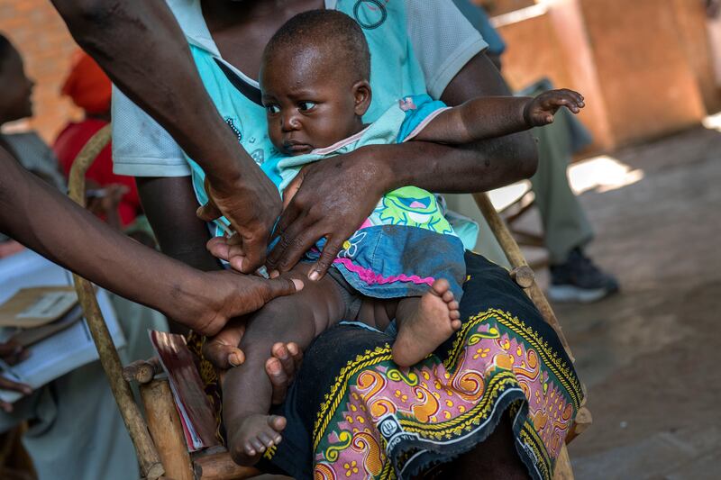 FILE - A baby from the Malawi village of Tomali is injected with the world's first vaccine against malaria in a pilot program, in Tomali, Dec.  11, 2019.  As the World Health Organization announces Thursday July 21, 2022 the next step in its rollout of the world's first authorized malaria vaccine in several African countries, the Bill and Melinda Gates Foundation says it will no longer financially support the shot.  (AP Photo / Jerome Delay, File)