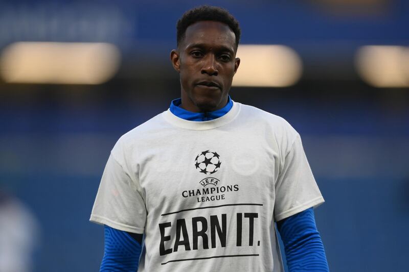 Brighton's Danny Welbeck warms up for the match at Chelsea wearing a t-shirt with a message in protest against the European Super League. Getty