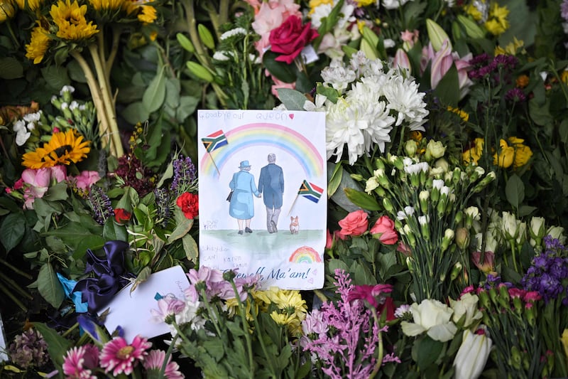 A drawing of the queen and her husband Prince Philip among flowers outside Windsor Castle. AFP