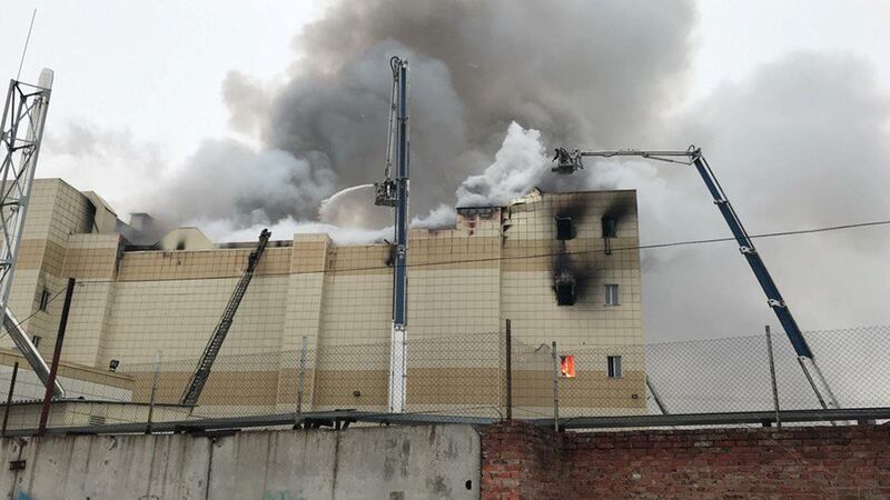 Firefighters extinguish a fire at a shopping mall in Kemerovo, Russia. Dmitry Saturin / Reuters