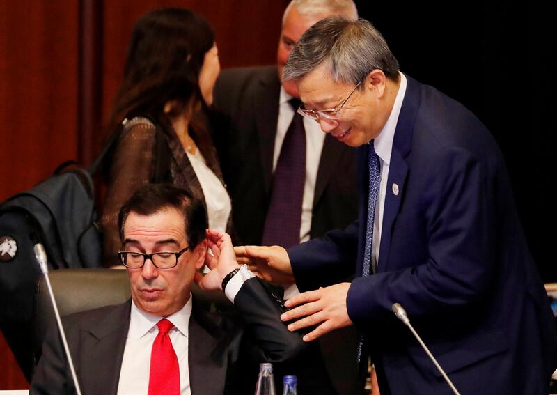 China's Central Bank Governor Yi Gang, right, approaches to greet U.S. Treasury Secretary Steven Mnuchin during the G20 Finance Ministers and Central Bank Governors Meeting, Saturday, June 8, 2019, in Fukuoka, Japan. (Kim Kyung-hoon/Pool Photo via AP)