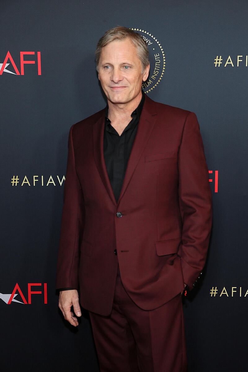 Actor Viggo Mortensen, who represents dramedy 'Green Book', poses in a striking burgundy suit. REUTERS