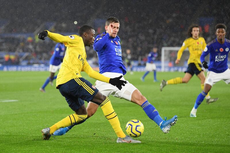 Nicolas Pepe of Arsenal passes the ball under pressure from Dennis Praet of Leicester. Getty