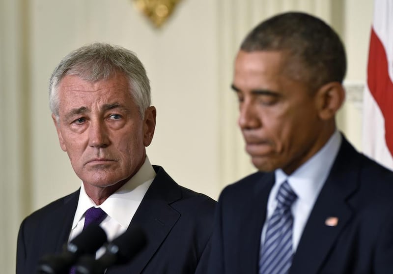 US defence secretary Chuck Hagel, left, is stepping down following a tenure in which he has struggled to break through the White House's insular foreign policy team. AP Photo/Susan Walsh