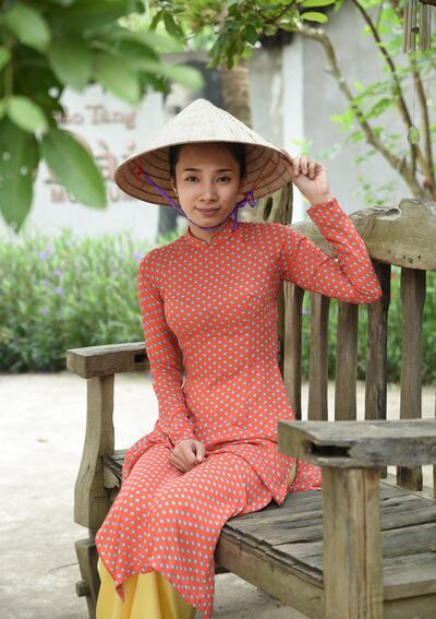 The ao dai consists of loose trousers worn beneath a long-sleeved, slender tunic with a high, Mandarin neckline. Courtesy Ronan O'Connell