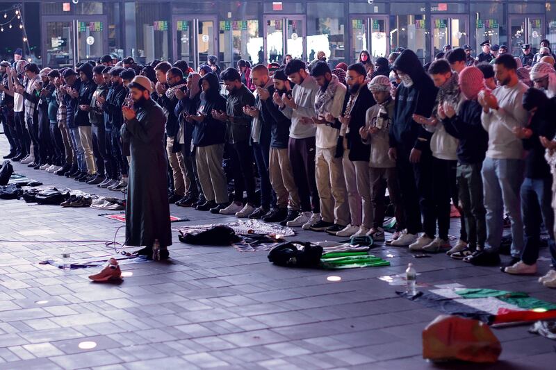 Men pray during a rally in support of Palestinians outside Barclays Centre in Brooklyn, New York. AFP