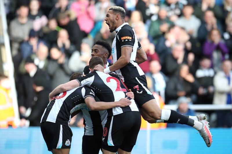 Ryan Fraser celebrates with teammates Joe Willock and Joelinton of Newcastle United after scoring their first goal in the 2-1 win against Brighton. Getty