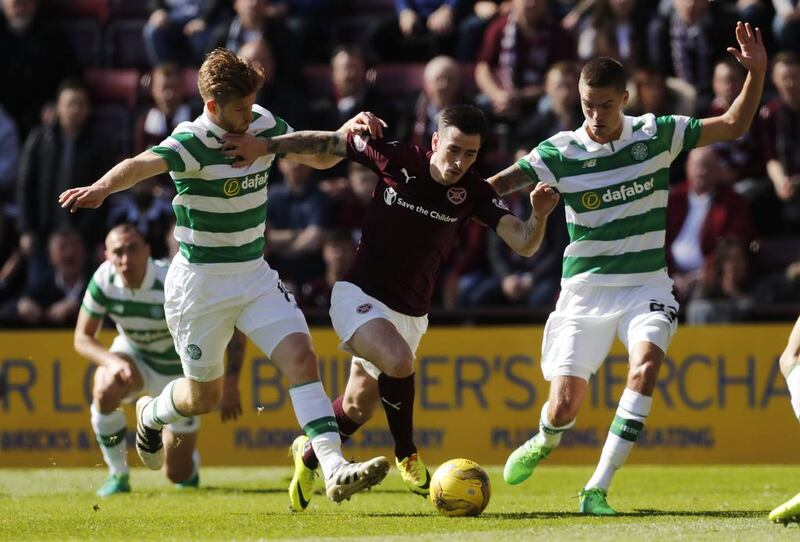 Celtic’s Stuart Armstrong (L) and Celtic’s Mikael Lustig in action with Heart’s Jamie Walker.   Russell Cheyne / Reuters