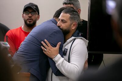 Illinois politician Abdelnasser Rashid embraces Odey Al Fayoume, father of Wadea Al Fayoume, at the Muslim Community Centre in  Chicago. AP