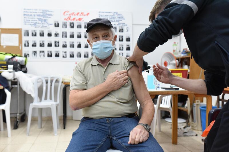 An Israeli man receives a coronavirus vaccine from the Magen David Adom emergency services, in Pisgat Ze'ev, an Israeli settlement in occupied East Jerusalem. All photos Rosie Scammell for The National