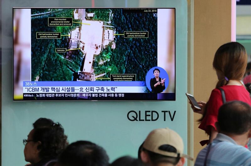 A TV screen shows a satellite image of North Korea's Sohae launch site, during a news program at the Seoul Railway Station in Seoul, South Kore, Tuesday, July 24, 2018. A U.S. research group says North Korea has started dismantling key facilities at its main satellite launch site in what appears to be a step toward fulfilling a commitment made by leader Kim Jong Un at his summit with President Donald Trump in June. The signs read: "Key facilities of an intercontinental ballistic missile (ICBM)." (AP Photo/Ahn Young-joon)