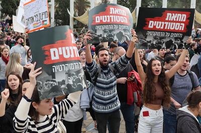Israeli students hold signs in Hebrew saying, 'Israeli students fighting for democracy', at a demonstration against Prime Minister Benjamin Netanyahu's new government, at Tel Aviv University. AFP