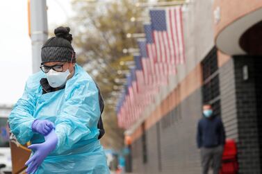 An Emergency Medical Technician dons personal protective equipment before going into Elmhurst Hospital during the outbreak of the coronavirus disease in Queens, New York, US, April 20. Lucas Jackson/ Reuters 