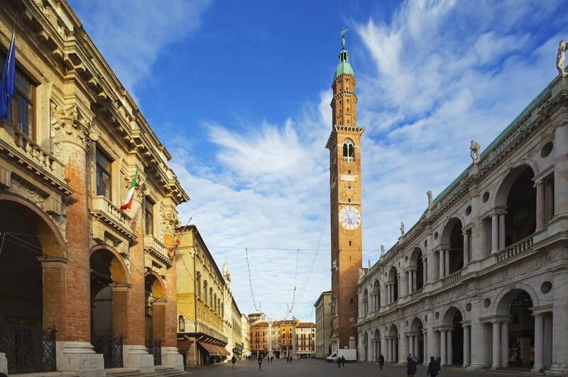 Piazza Signori in Vicenza, with the clock tower on the Basilica Palladiana, which houses shops in its arches. AWL Images / Getty Images