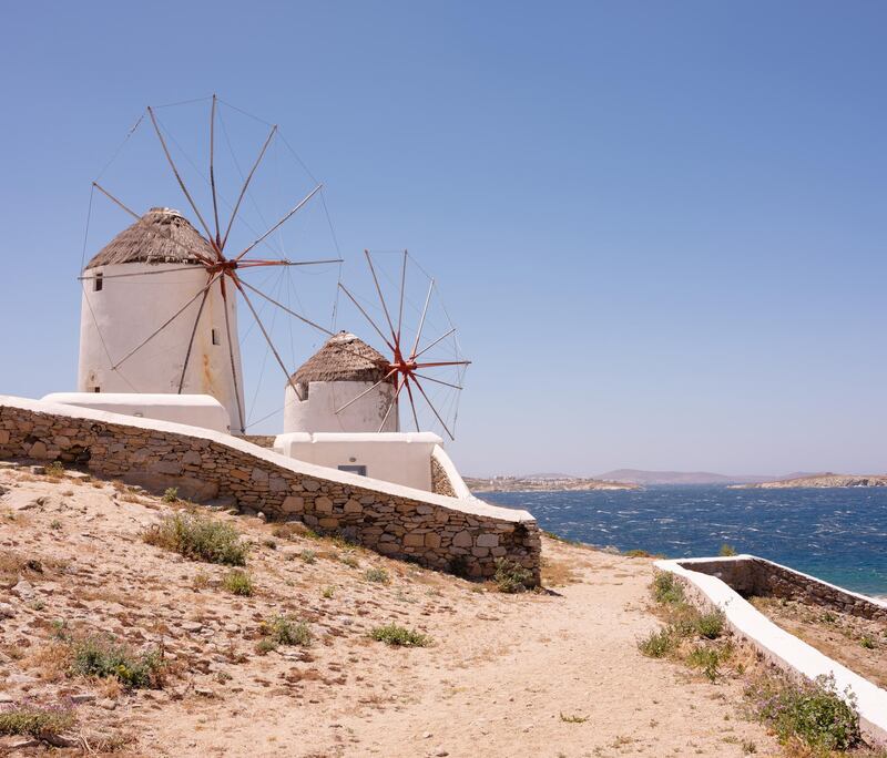 The landmark Mykonos windmills overlooking the sea in Mykonos, Greece. Photographer: Loulou D'Aki/Bloomberg