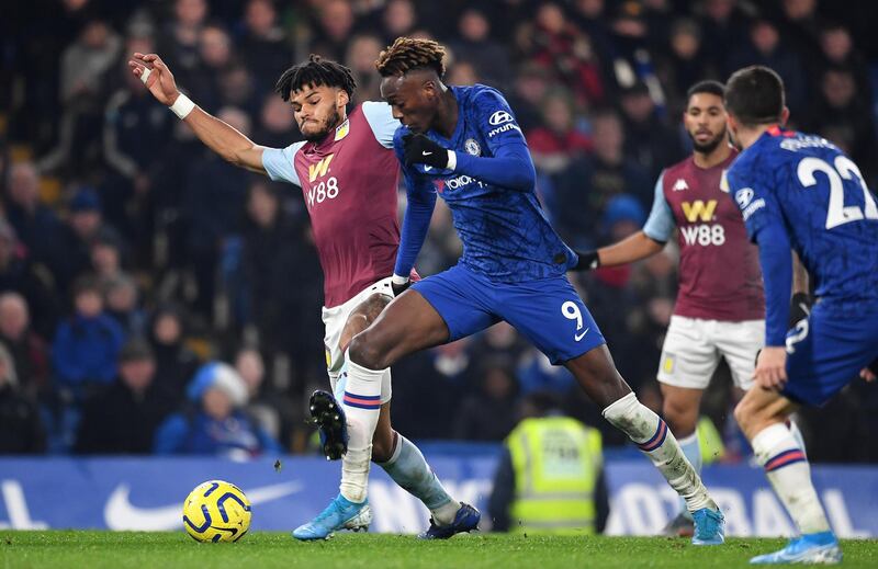 Tammy Abraham vies for the ball with  Tyrone Mings. EPA