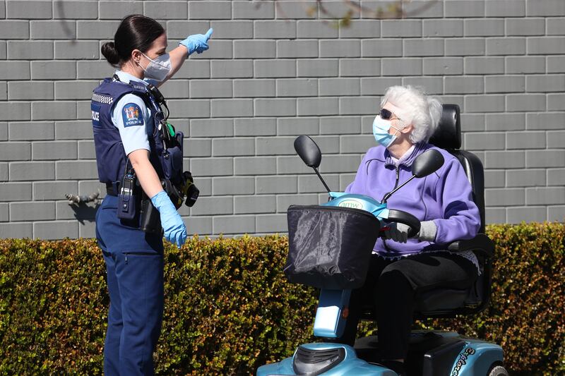 A police office directs a shopper away from the closed Lynn Mall. Getty Images