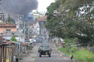 Smoke billows from burning houses in Marawi during fighting between the Philippine military and ISIS-linked militants who seized the city on Mindanao island for several months in 2017. AFP

