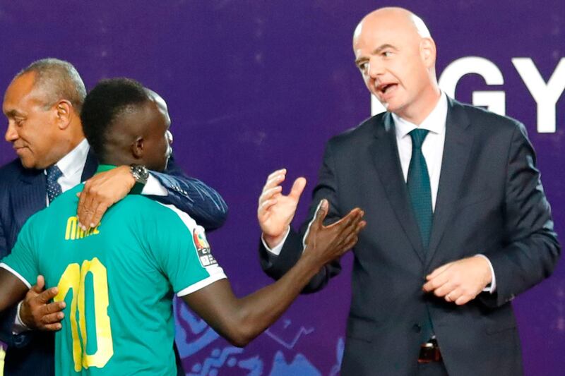 Mane is greeted by Infantino as he collects his medal. AFP