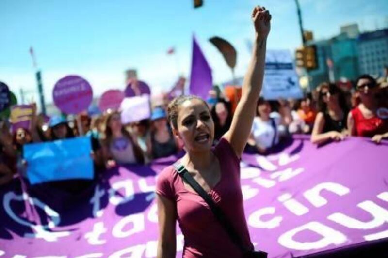 Protesters chant slogans at Taksim Square in Istanbul on Saturday, the ninth day of protests in the city. Bulent Kilic / AFP