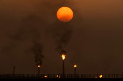 The sun sets as flare stacks burn off excess gas at the Mushrif site inside the Zubair oil and gas field, north of the southern Iraqi province of Basra last week. AFP