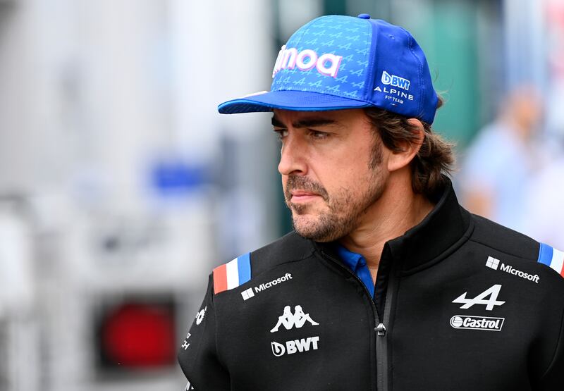 Alpine driver Fernando Alonso of Spain walks through paddock prior the Hungarian Formula One Grand Prix. AP Photo