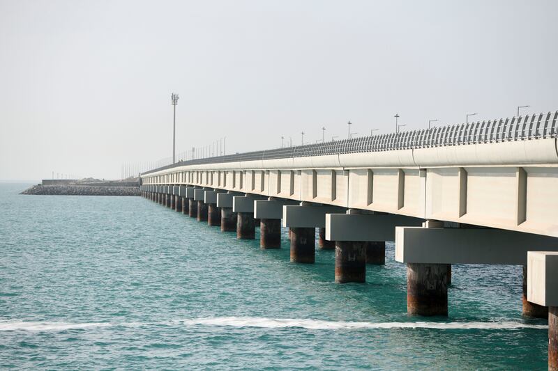 It stretches a kilometre across the Arabian Gulf and connects Abu Dhabi’s sprawling Khalifa Port to the emirate's mainland. Khushnum Bhandari / The National