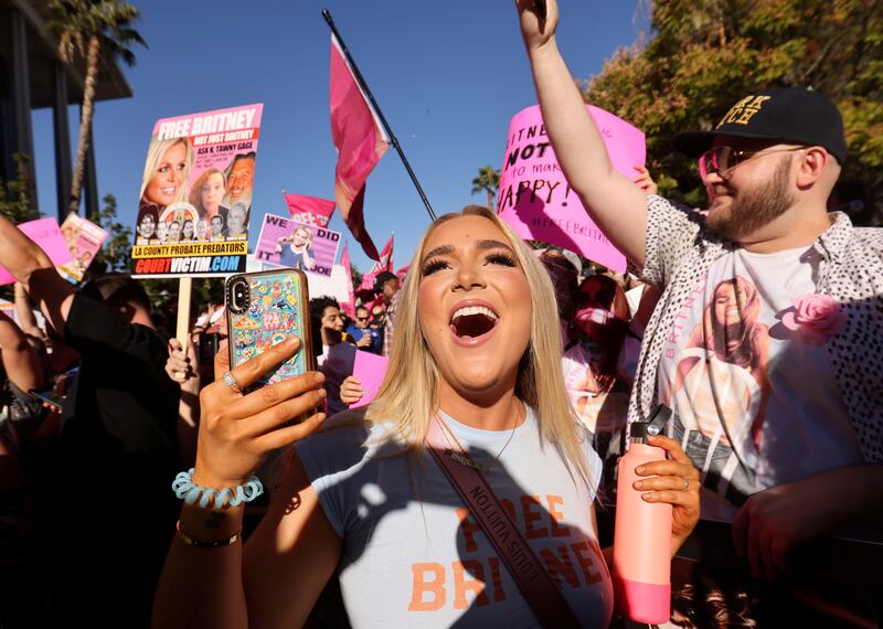 Supporters of singer Britney Spears celebrate outside the Stanley Mosk Courthouse in Los Angeles as Spears's conservatorship is terminated. Reuters