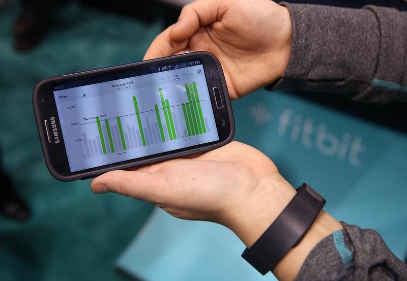 Data collected from the Fitbit Force is displayed on a smartphone at the 2014 International Consumer Electronics Show in Las Vegas, Nevada. Fitbit has issued a voluntary recall on its Force wristbands after reports began surfacing in January that the device was causing a painful skin irritation for some users. Justin Sullivan / Getty Images / AFP