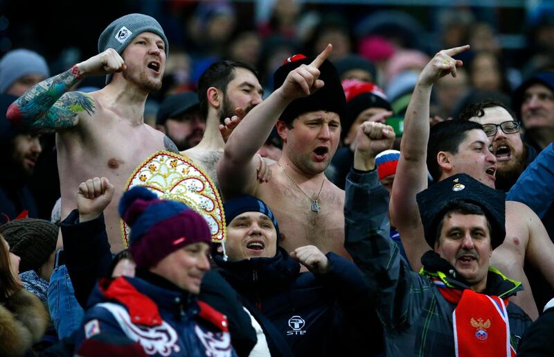 FILE - In this Friday, March 23, 2018 file photo, Russia supporters gesture on the stands during an international friendly soccer match between Russia and Brazil at the Luzhniki stadium in Moscow, Russia. Racist and anti-gay chants have become more common in Russian soccer as the country prepares to host the World Cup, even as overall incidents of discrimination declined. (AP Photo/Alexander Zemlianichenko, File)