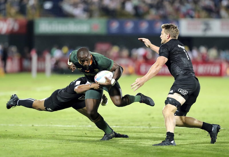 Dubai, United Arab Emirates - December 07, 2019: Siviwe Soyizwapi of South Africa is tackled by Ngarohi McGarvey-Black of New Zealand during the game between New Zealand and South Africa in the mens final at the HSBC rugby sevens series 2020. Saturday, December 7th, 2019. The Sevens, Dubai. Chris Whiteoak / The National
