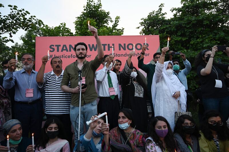 Women rights activists hold placards and candles during a protest rally against the brutal killing of Noor Mukadam, the daughter of a former Pakistani diplomat who was found murdered at a house in Pakistan's capital on July 20, in Islamabad. AFP