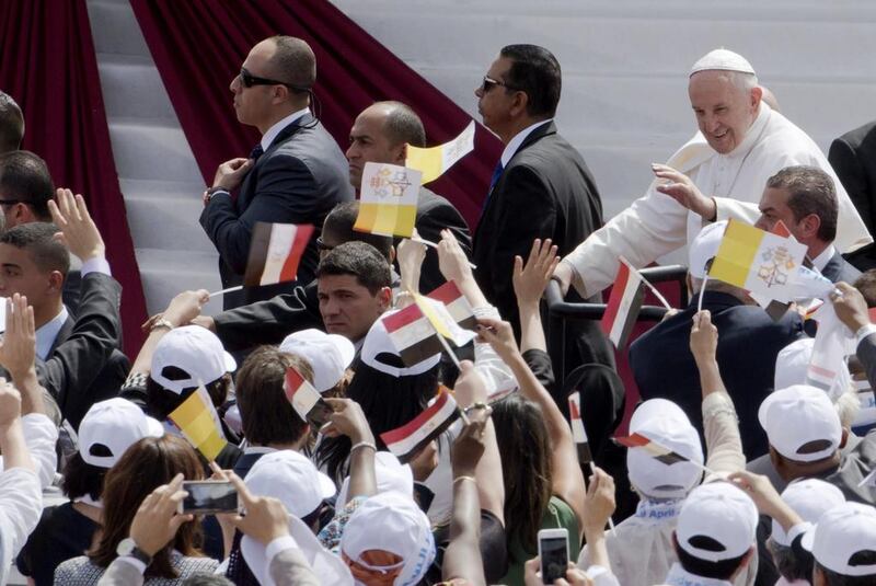 Pope Francis waves as he arrives to celebrate mass for Egypt's tiny Catholic community at the Air Defence Stadium in Cairo on April 29, 2017. Amr Nabil / AP Photo