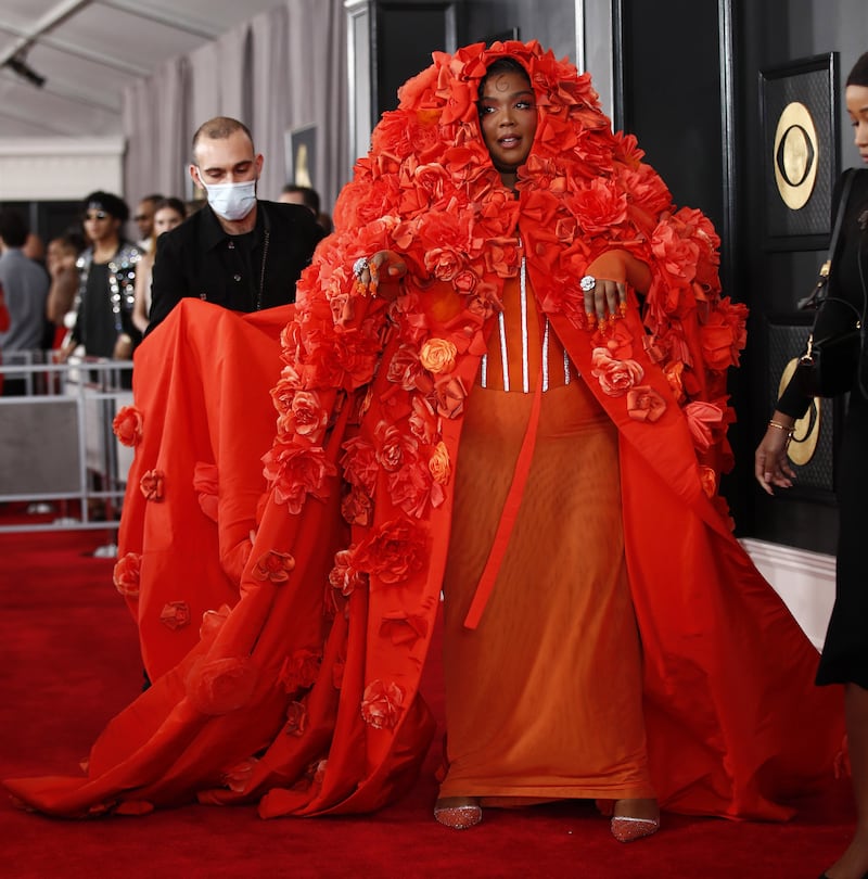 Lizzo arrives in a red floral caped dress by Dolce & Gabbana.   EPA