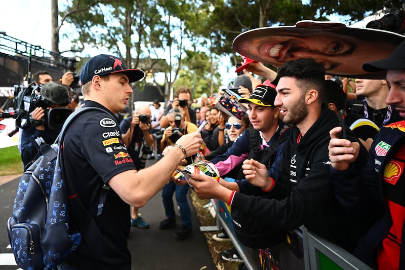 Max Verstappen arrives at the circuit and signs autographs for fans. Getty