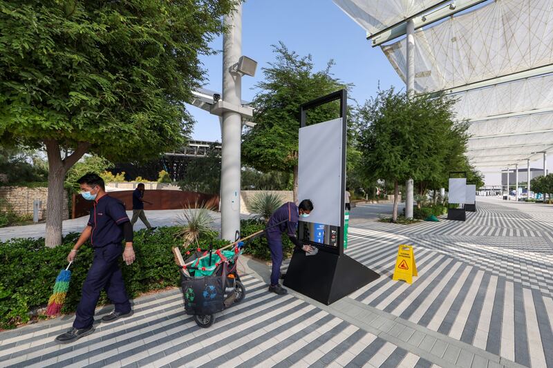 Workers clean street furniture in the Green Zone. Bloomberg