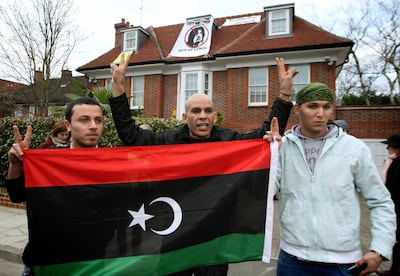 Members of a group calling themselves "Topple The Tyrants" outside a house owned by Saadi Qaddafi but used by Saif Al Islam, in North London. PA
