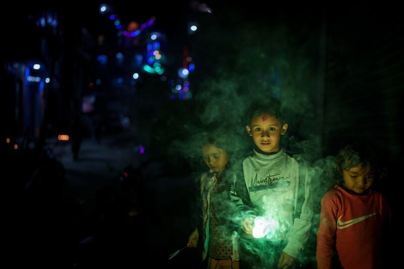 Children light firecrackers in Kathmandu. AP