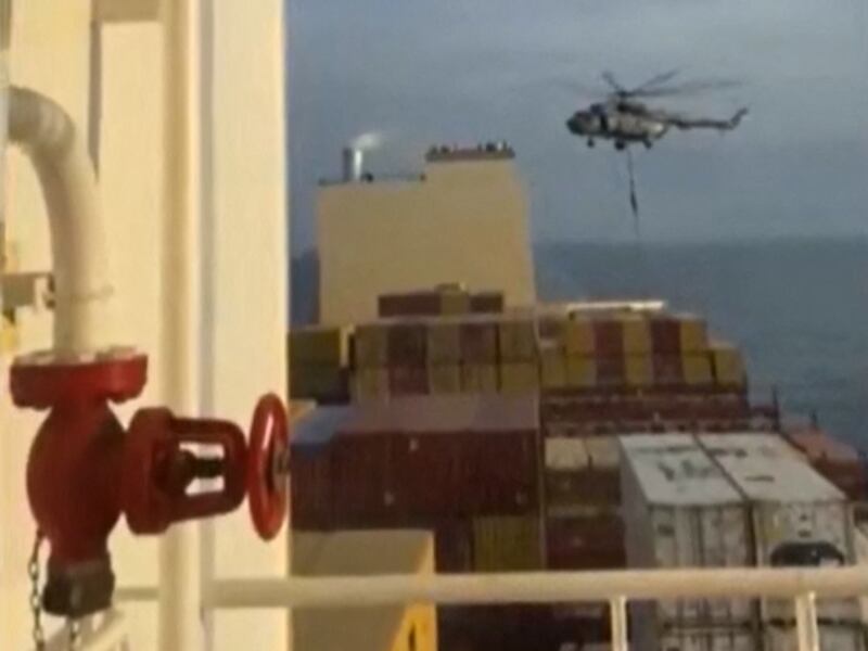 Iran's Revolutionary Guards rappel down onto a container ship named MSC Aries, near the Strait of Hormuz.  AFP