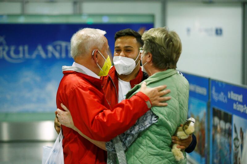 People reunite after a Lufthansa plane transporting evacuees from Kabul, Afghanistan, lands in Frankfurt, Germany.
