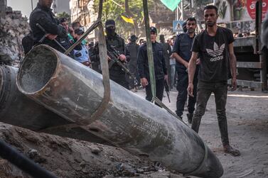 People gather and watch the removal of unexploded ordnance as a ceasefire came into effect on May 21, 2021 in Gaza City, Gaza. Getty Images