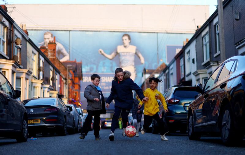 Young Everton fans play football outside Goodison Park before their team plays Tottenham. Reuters