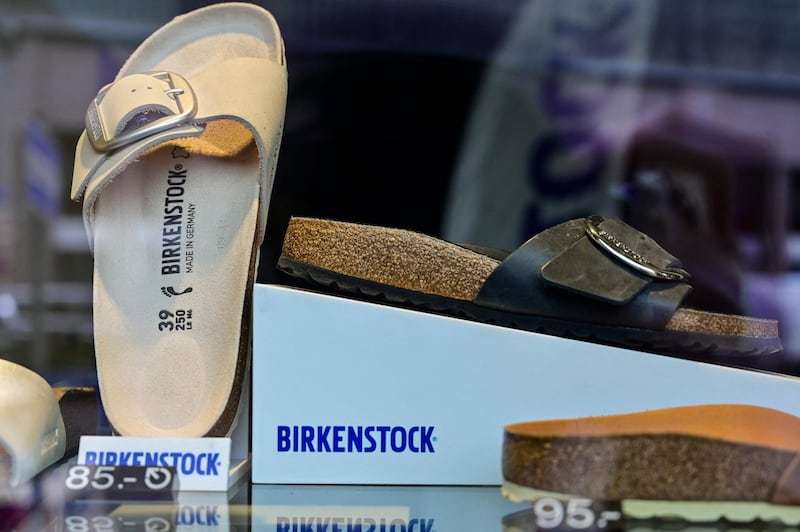 Sandals of the German sandals and shoes maker Birkenstock are pictured in a store window at the company's store in Berlin on February 26, 2021. Germany's unabashedly frumpy but comfortable flat sandals Birkenstock stepped into the luxury leagues on February 26, 2021, with an LVMH-backed company and the French group's billionaire owner snapping up a majority stake in the iconic brand.
 / AFP / John MACDOUGALL
