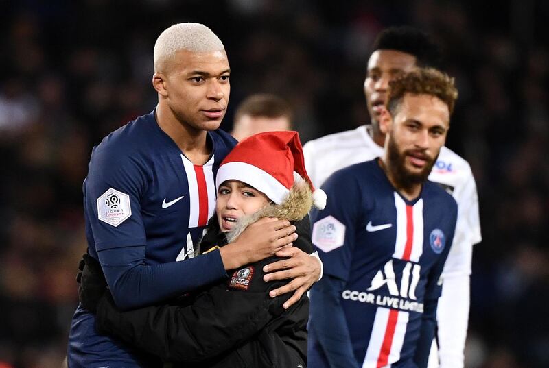 Mbappe and the young fan. AFP