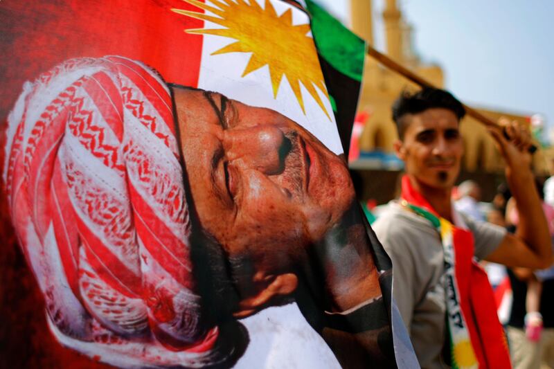 A man holds a Kurdish flag with a picture of Iraqi Kurdish leader Masoud Barzani during a gathering at Martyrs Square in Downtown Beirut, Lebanon to support next week's referendum in Iraq. Hassan Ammar / AP Photo