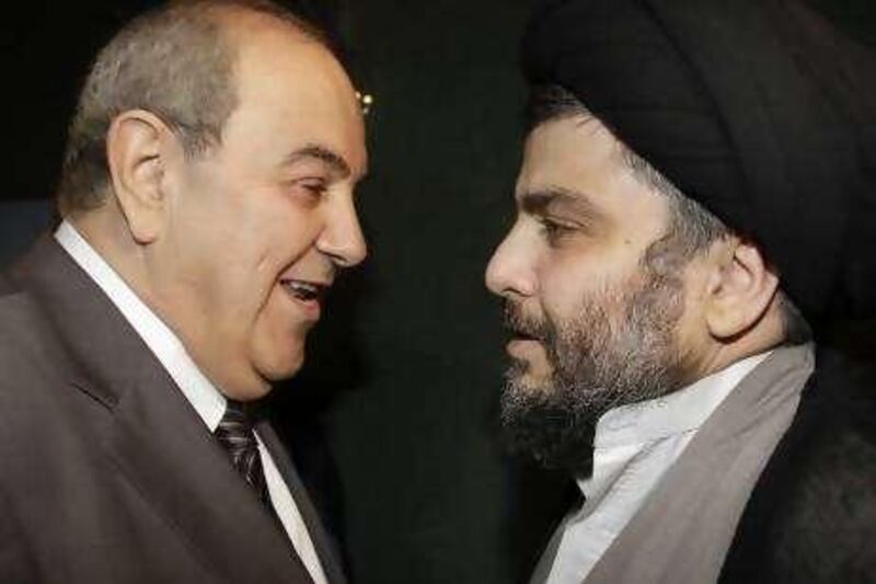 Iraqi Shiite cleric Moqtada al-Sadr welcomes former Iraq's Prime Minister Iyad Allawi (L) before a meeting in Damascus July 19, 2010. REUTERS/Khaled al-Hariri   (SYRIA - Tags: POLITICS) *** Local Caption ***  SYR07_SYRIA-_0719_11.JPG