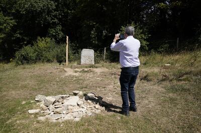 A man photographs the stone marking the spot for the traditional source of the River Thames known as Thames Head. PA